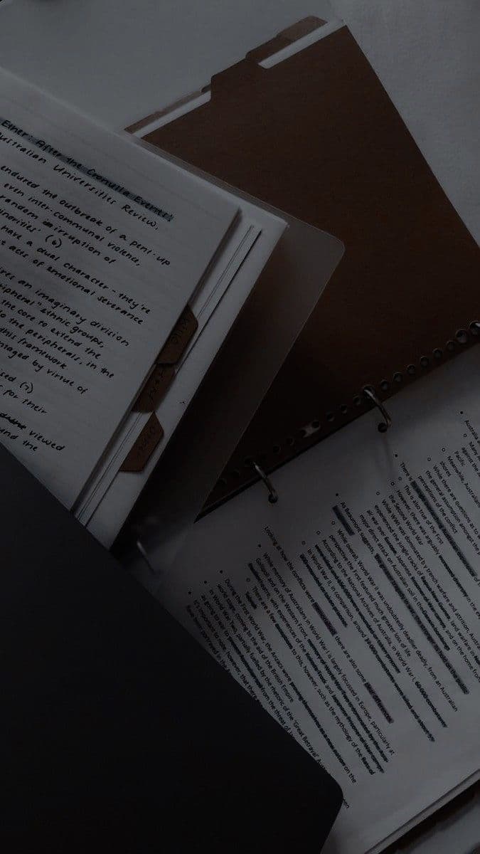 Open ring binder with handwritten study notes and a printed page about Australian history.